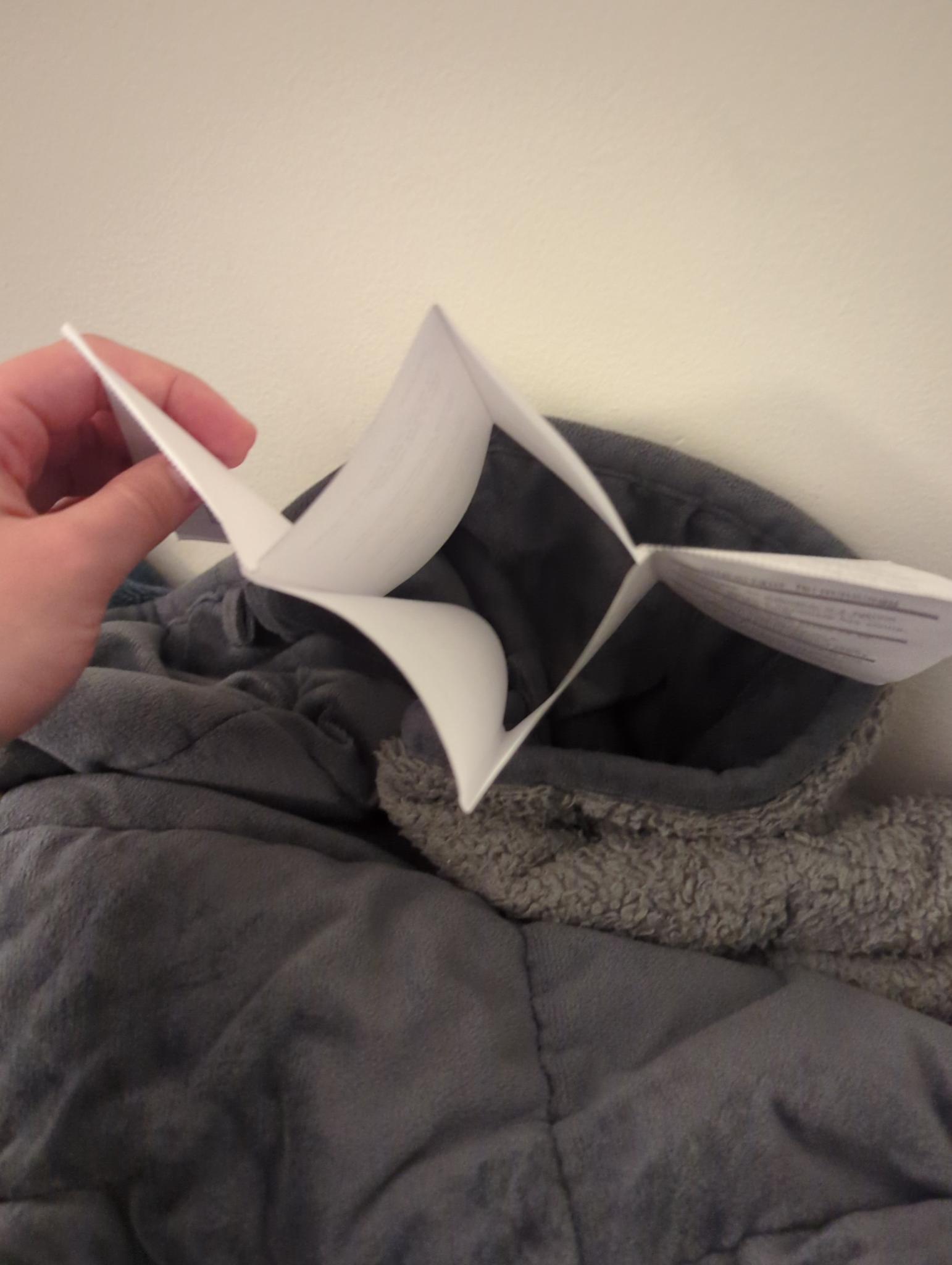 paper folded such that it has an opening in it where it was cut open in the center